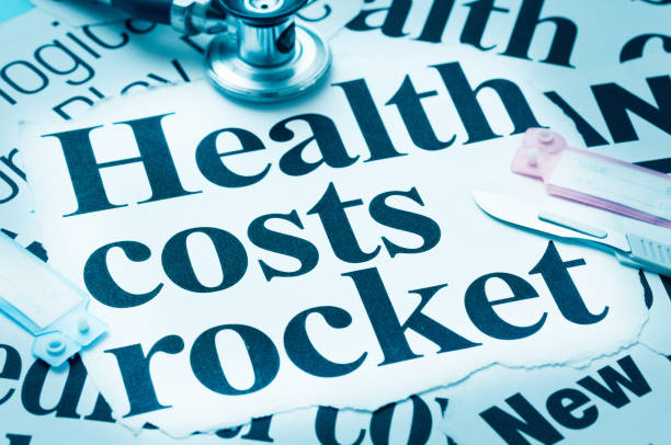 Still life of newspaper headlines and stethoscope, on the theme of inflation in medical costs.